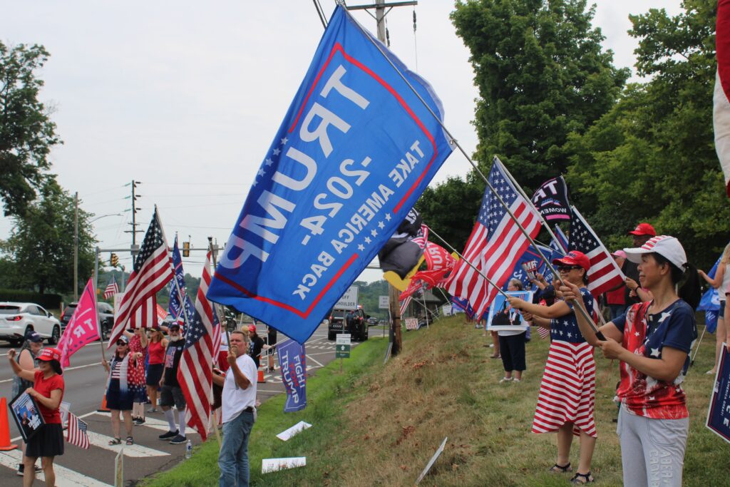 Trump-rally10 Dozens of Trump supporters waved flags and signs by the side of the road in Doylestown on July 20, 2024. (Emily Neil/WHYY)