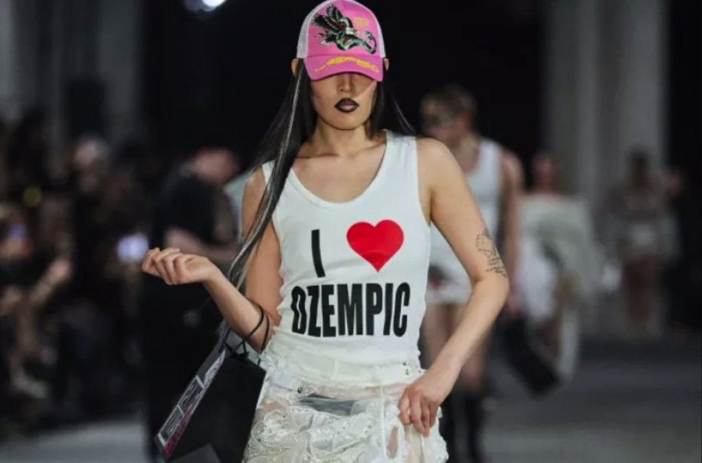 berlin-fashion-show-npr-2024-04-10 Model wearing a shirt saying