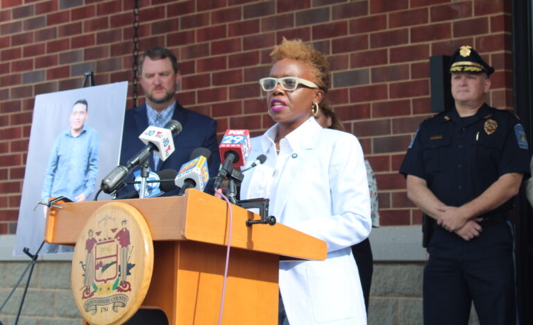 Dr. Janine Darby speaking at a podium
