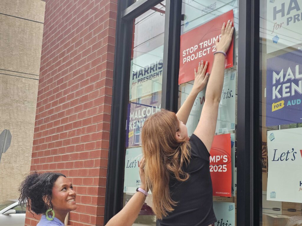 harris-campaign-philadelphia-2 Workers put Harris campaign signs on a window