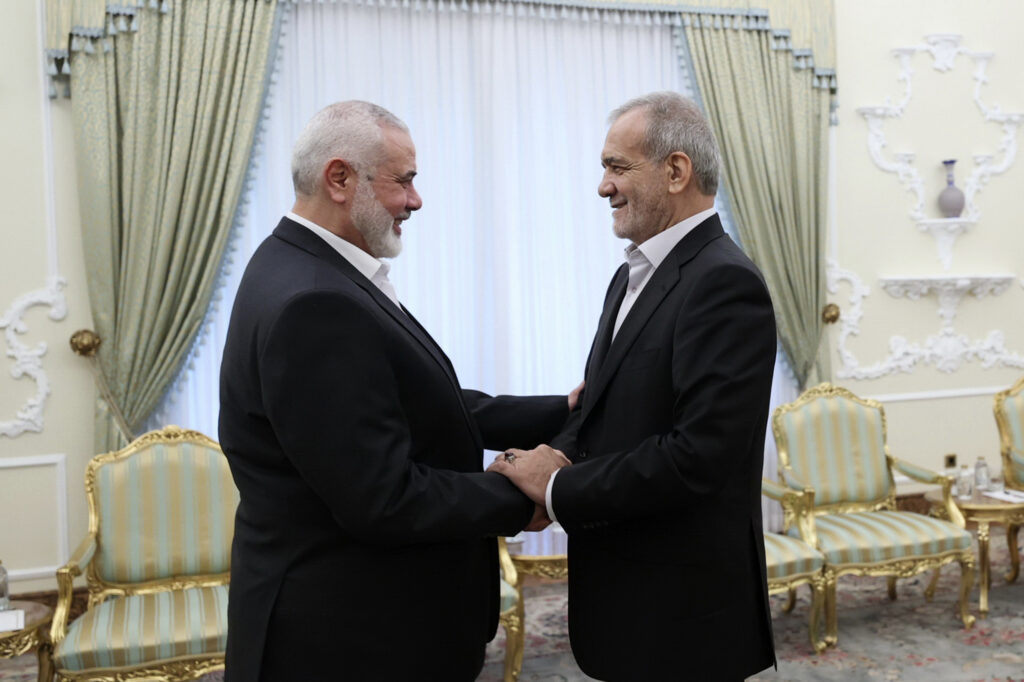 Iran Palestinians In this photo released by the Iranian Presidency Office, President Masoud Pezeshkian, right, shakes hands with Hamas chief Ismail Haniyeh at the start of their meeting at the President's office in Tehran, Iran, Tuesday, July 30, 2024.