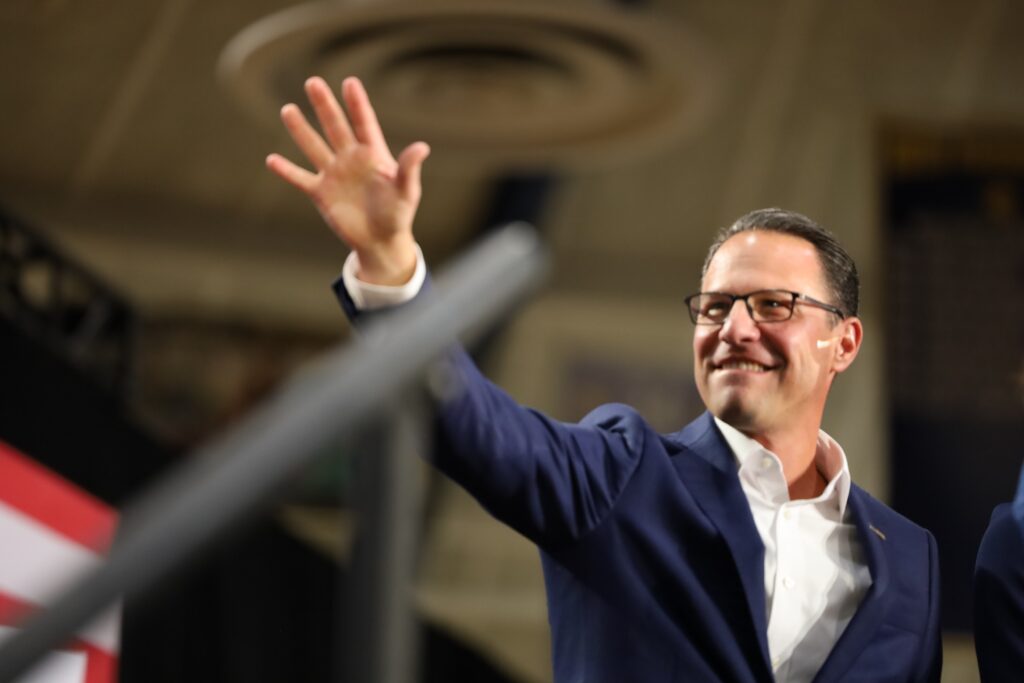 shapiro-whitmer-montgomery-county-july-2024-4 Gov. Josh Shapiro waves to the crowd at a campaign event in Montgomery County for Kamala Harris with Gov. Gretchen Whitmer of Michigan. (Carmen Russell-Sluchansky)