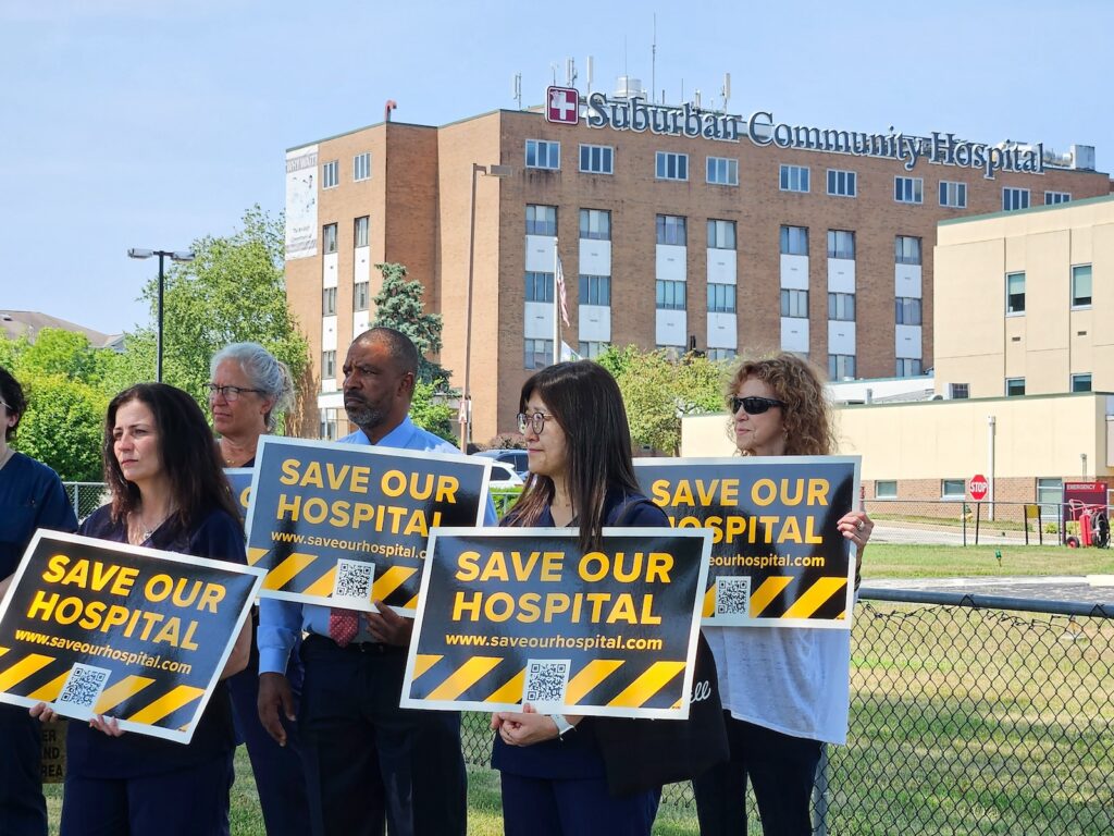 suburban-community-hospital-micro-layoffs-NL-071824-01 Hospital workers rally in front of Suburban Community Hospital on July 17, 2024, as it transitions to a