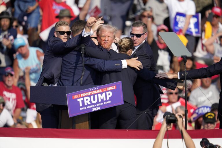 Republican presidential candidate former President Donald Trump is surround by U.S. Secret Service agents at a campaign event in Butler, Pa., Saturday, July 13, 2024.