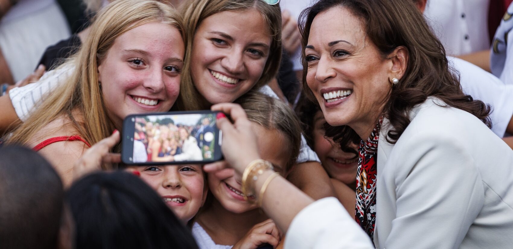 Kamala Harris posing for a photo with young women