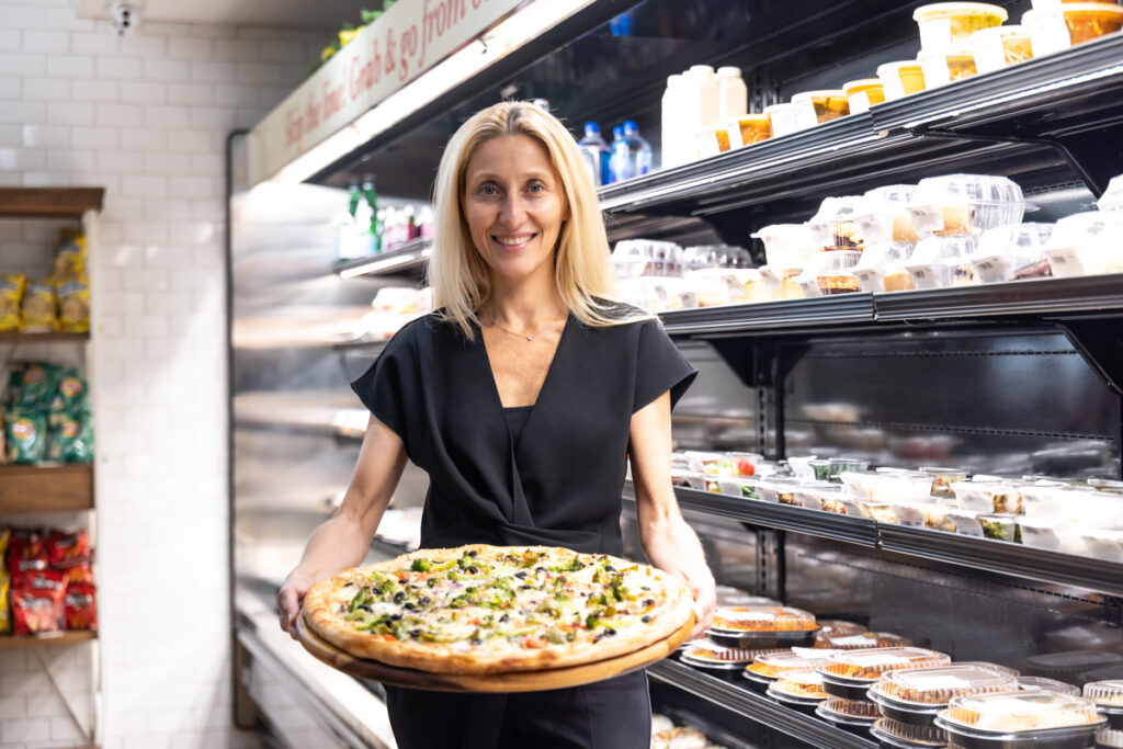 07 11 2024 k paynter lamberti pizza center city business-3 Rosita Lamberti, director of restaurants for the Aldo Lamberti family of restaurants, holds a pizza inside Lamberti’s at 7th and Chestnut in Center City, Philadelphia