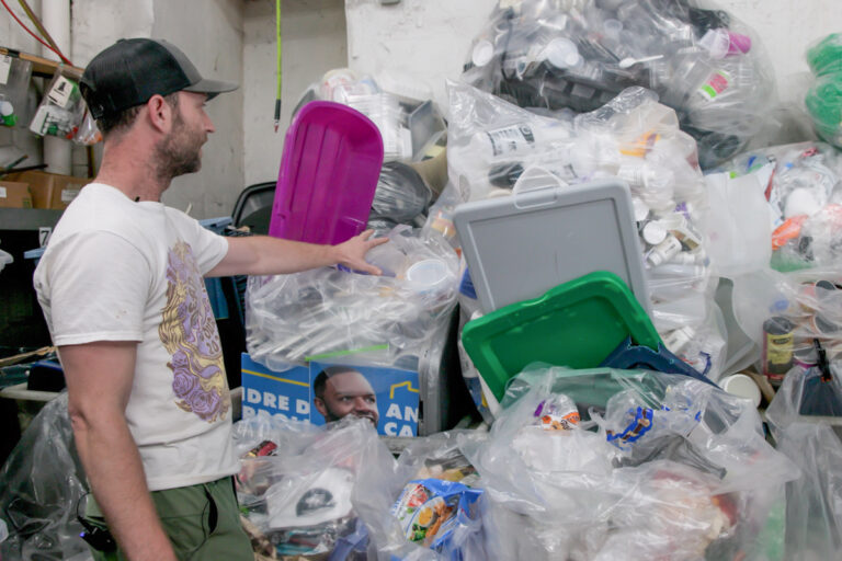 Matt Siegfrield showing the types of plastic they recycle