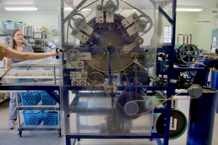 Melissa Smith operates a machine next to Susan Phillips