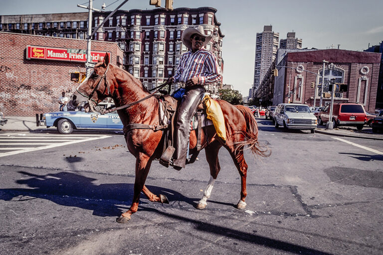 A Black horse rider rides a horse in New York City.