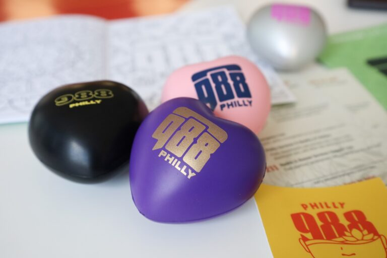 Jeme Agency, based in Philadelphia, created thousands of logos, images and designs for the 988 mental health and suicide crisis lifeline that can be put on posters, t-shirts, stress balls and other everyday items. (Nicole Leonard/WHYY)