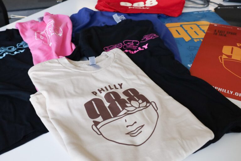 Jeme Agency, based in Philadelphia, created thousands of logos, images and designs for the 988 mental health and suicide crisis lifeline that can be put on posters, t-shirts, stress balls and other everyday items. (Nicole Leonard/WHYY)