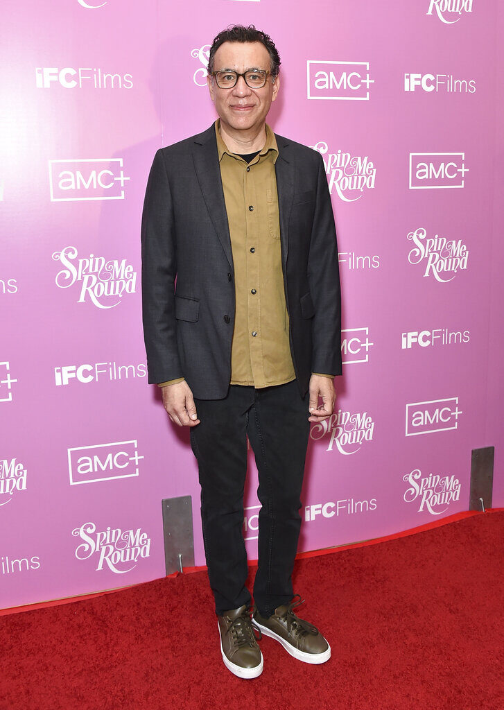 actor and comedian Fred Armisen stands in front of a pink background