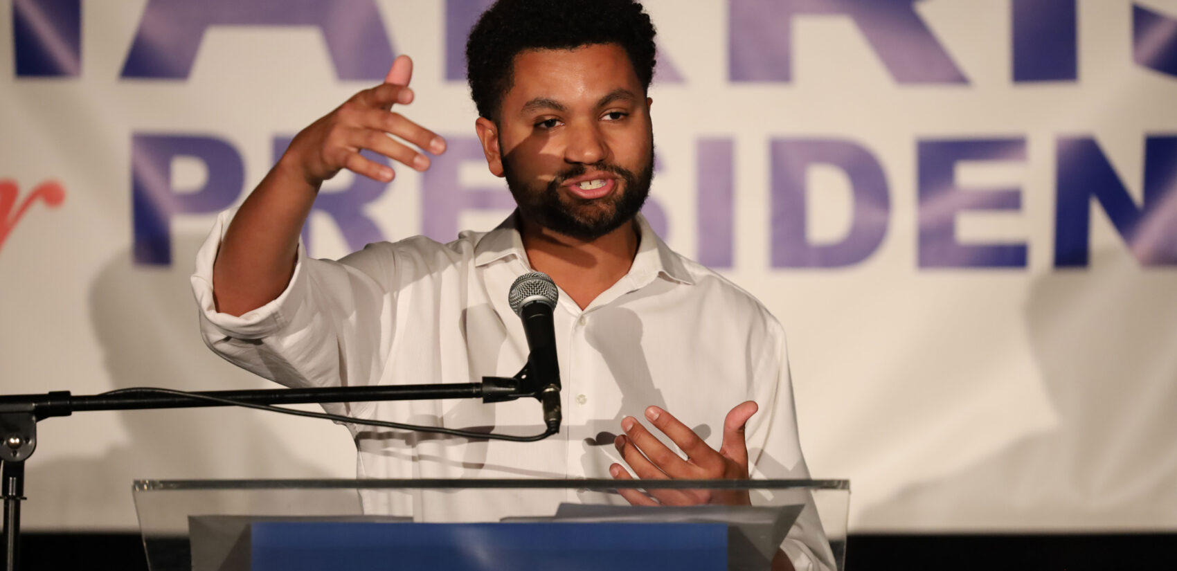 Maxwell Frost speaks behind a podium