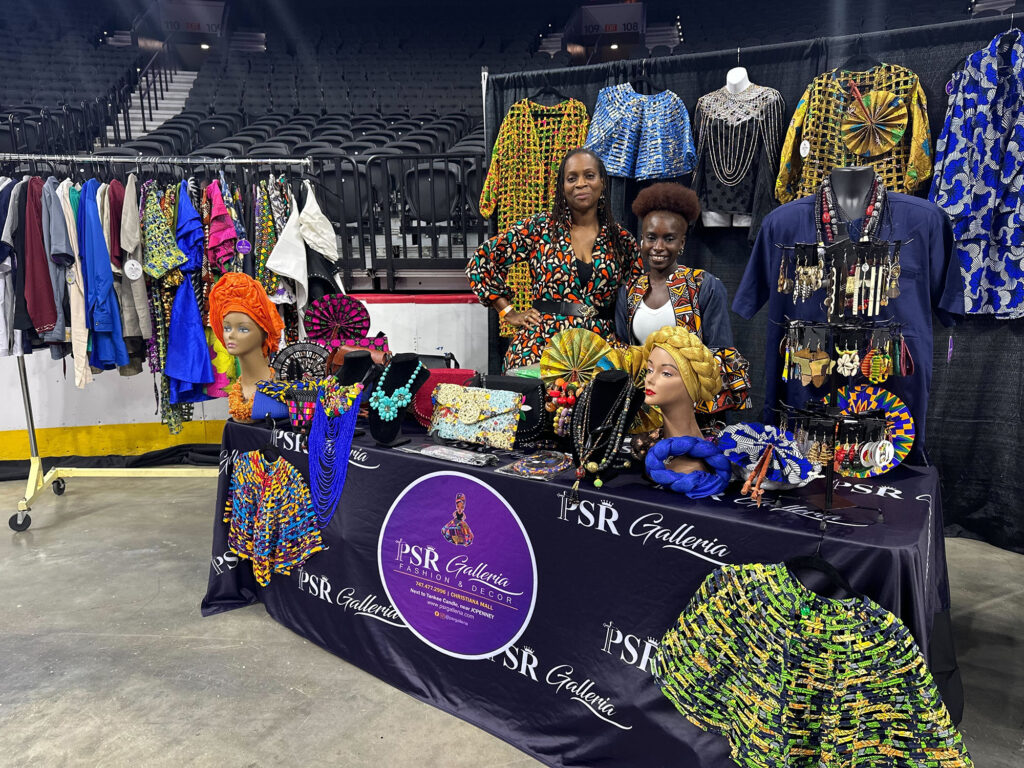Two women with PSR Galleria Rosetta pose at their stall at the Wells Fargo Center