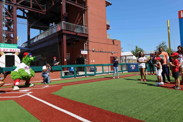 Student pitches ball to Phillies Phanatic mascot at Citizens Bank Park during School District of Philadelphia Ring the Bell event, August 13, 2024 (Photo Credit: Amanda Fitzpatrick)
