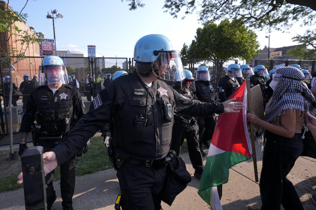 Election 2024 DNC Police direct protesters at the United Center after a march at the Democratic National Convention Monday, Aug. 19, 2024, in Chicago. (AP Photo/Alex Brandon)