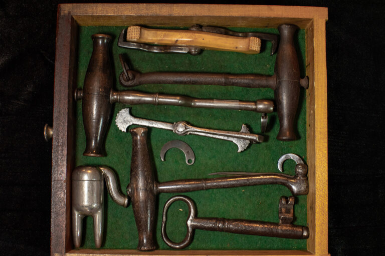 Old dental instruments sit in an open drawer