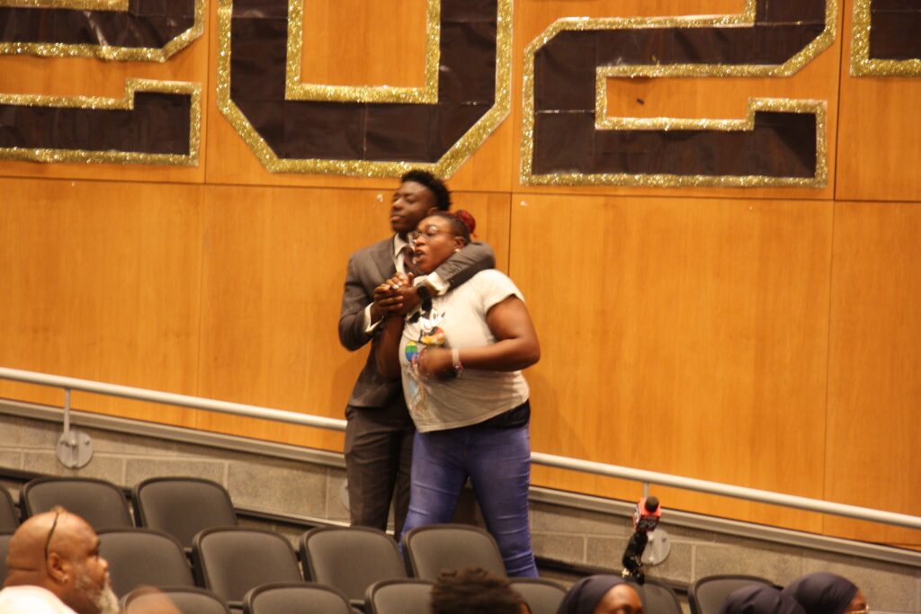 camden-county-school-district-meeting-2024-08-27-4 A man restrains a woman during the meeting
