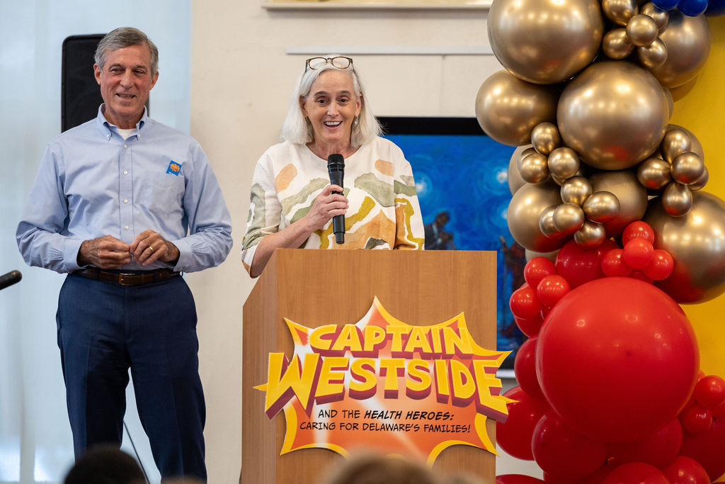 carneys-captain-westside-2 John Carney and a woman stand behind a podium