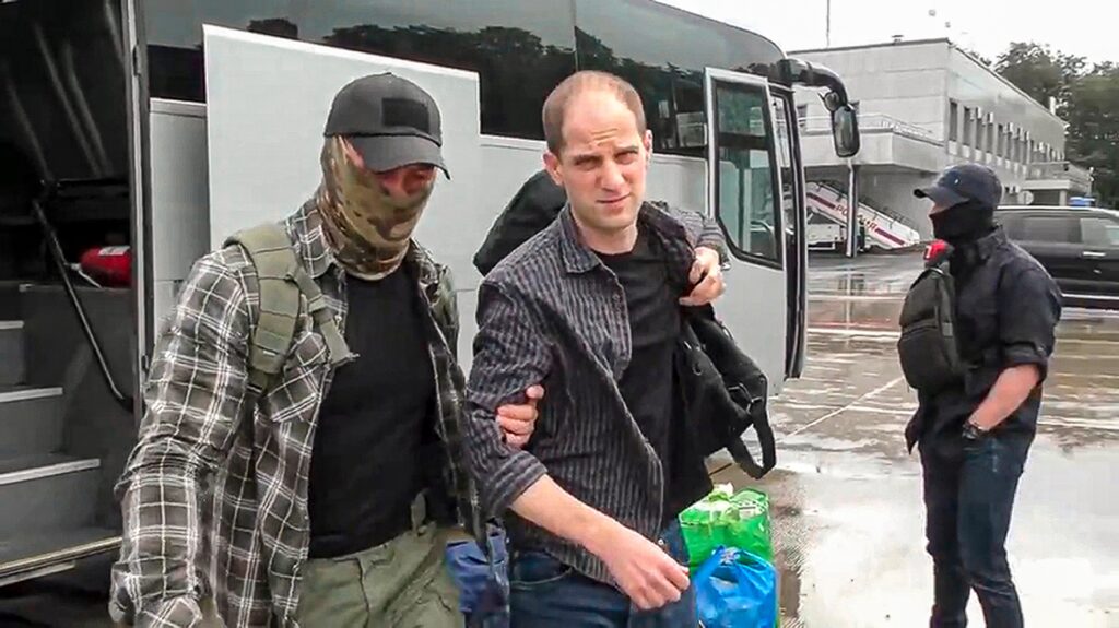 evan-gershkovich-russian-airport Evan Gershkovich is escorted by a Russian Federal Security Service agent