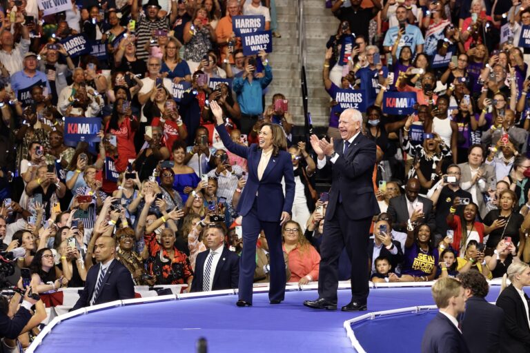 Kamala Harris Tim Walz greet the crowd at the rally