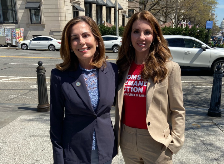 Kathy Jennings and Shannon Watts posing for a photo on the sidewalk