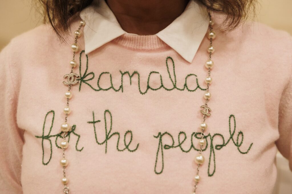 Election 2024 Voices of Women Carla Wicks the Rho Delta Omega Chapter of Alpha Kappa Alpha (AKA) Sorority, Inc., wears an embroidered