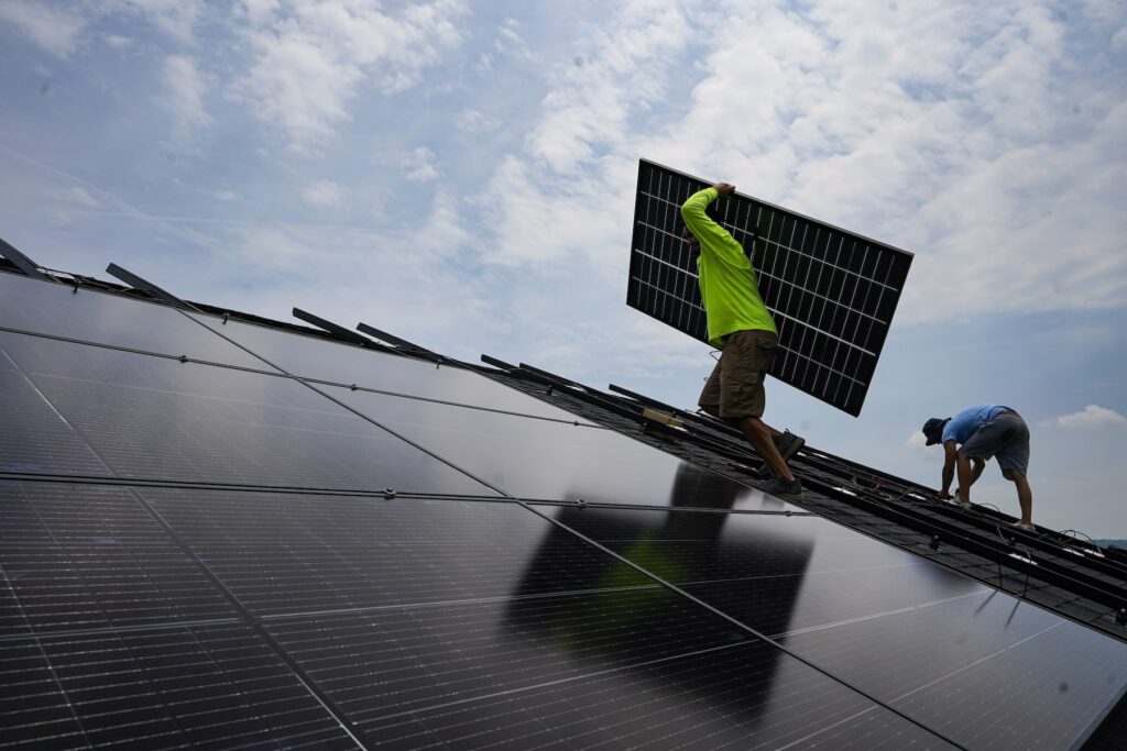Biden Inflation A crew installs a solar array on the roof of a home in Frankfort, Ky., in 2023.