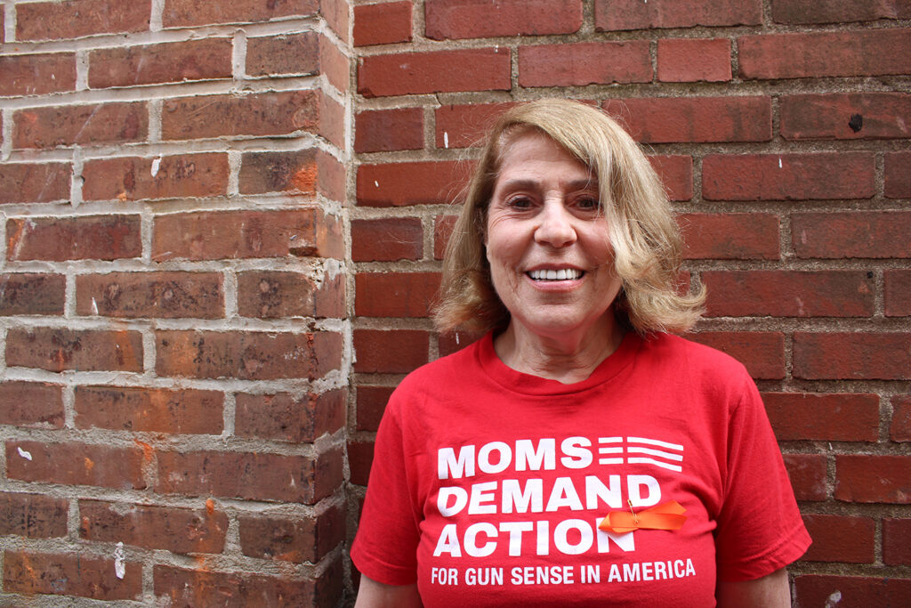 Debra O'Connor, of Moms Demand Action for Gun Sense in America, poses for a photo in front of a brick wall