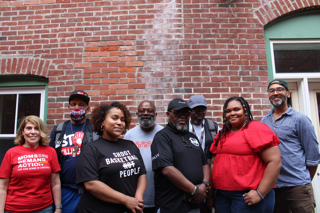Bridging Blocks public safety and belonging cookout Several people advocating against gun violence pose for a photo at WHYY's Bridging Blocks event August 17.