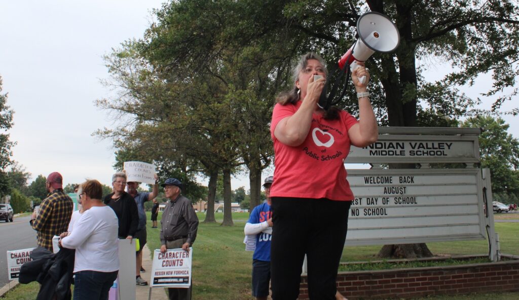 souderton-school-board-meeting-1 Stephanie Jamison speaks into a microphone at a rally ahead of the Souderton Area School District board meeting on Aug. 29, 2024