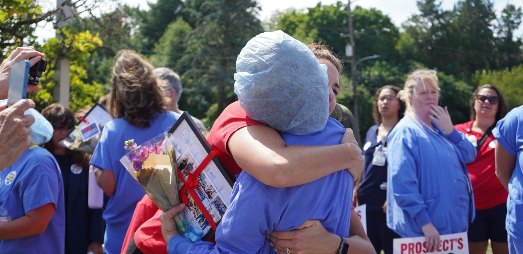 a PASNAP official hugs a nurse