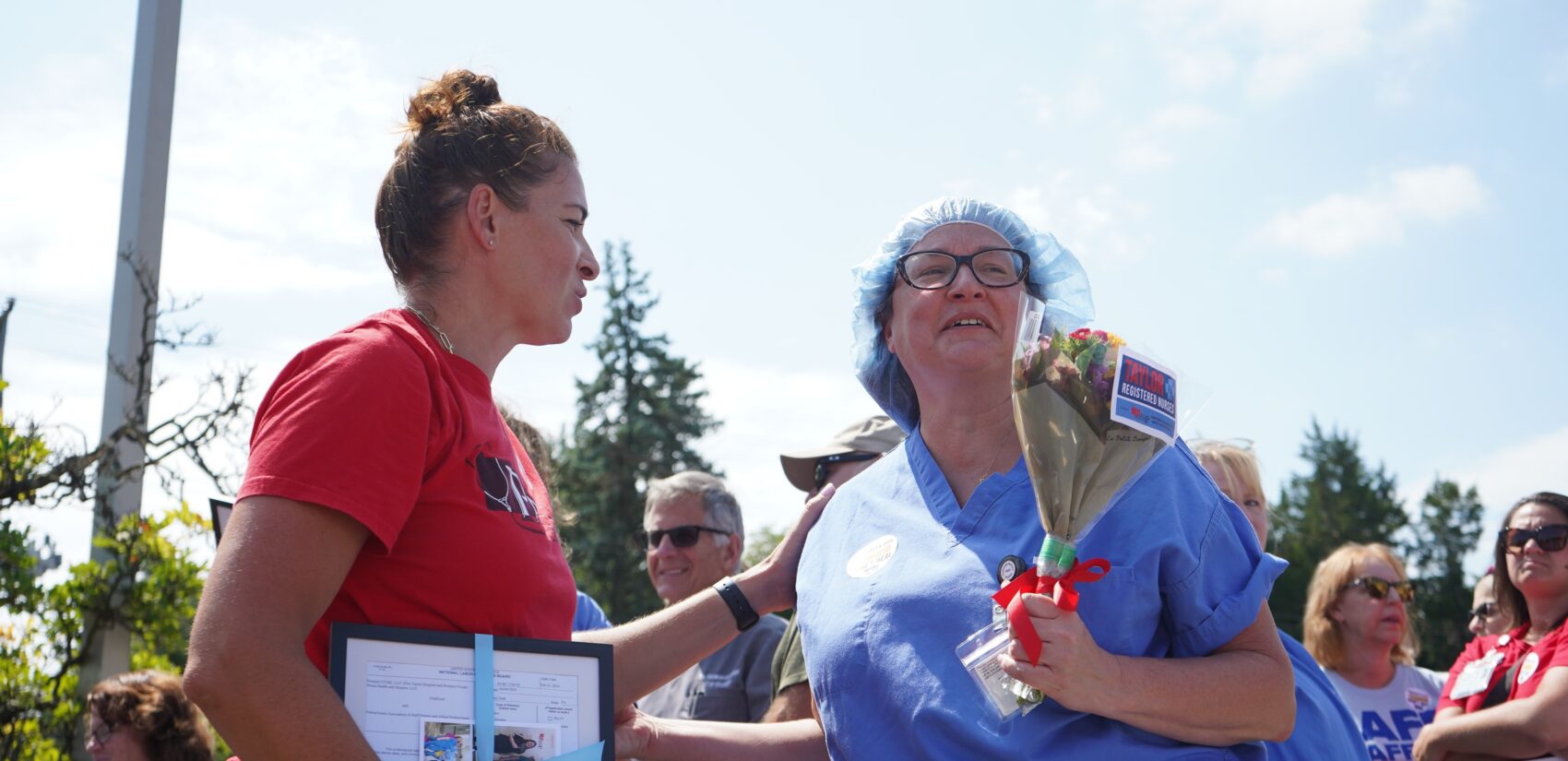 a nurse is presented with flowers