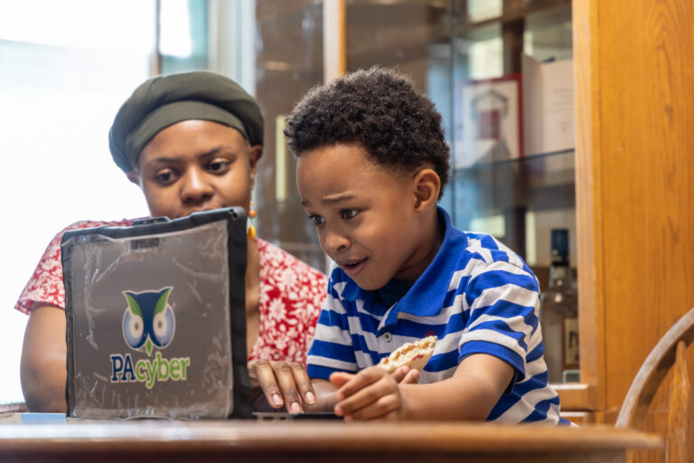 Austen, 6, works his way through an online class with the help of his mother, Constance. Constance decided to homeschool Austen who has autism due to a lack of support by local public schools. (Kimberly Paynter/WHYY)