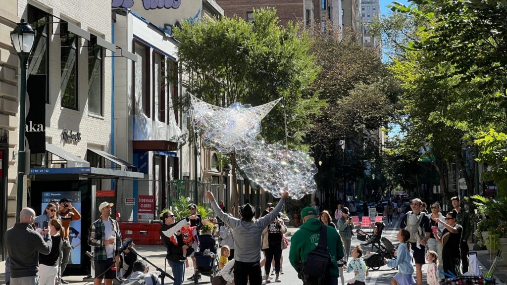 Pedestrians flooded Walnut Street A bubble artist entertained pedestrian on Walnut Street's first car-free Sunday of September 2024.