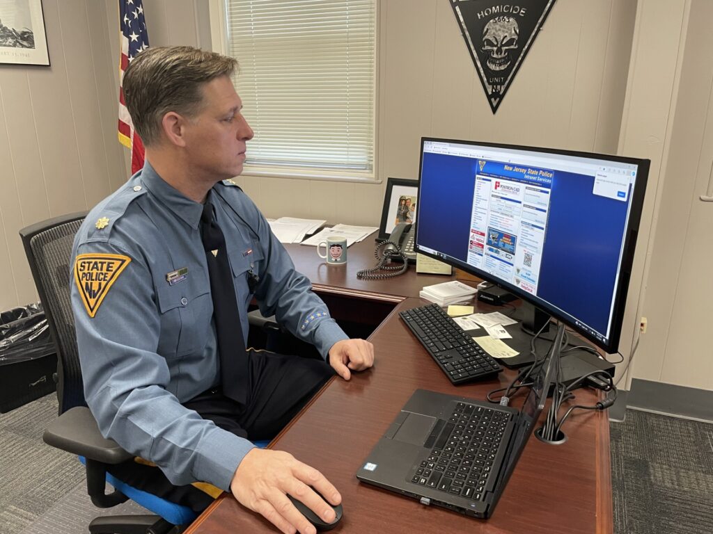 2024 09 03 nj_state_police_human_trafficking_unit2 New Jersey State Police Major Tom Wieczerak sits at a desk working on a computer