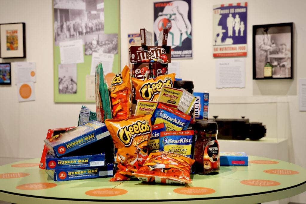 a stack of Cheetos, StarKist tuna and other snacks piled on top of each other, on display