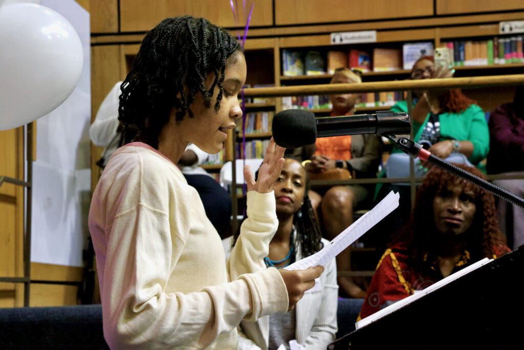 2024 0927-e lee-zawadi levy-philadelphia northwest regional library-healing verse germantown Zawadi Levy speaking at a podium