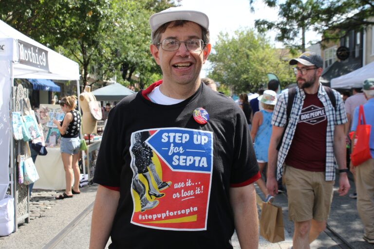 John Corbett smiles in a Step Up for SEPTA shirt