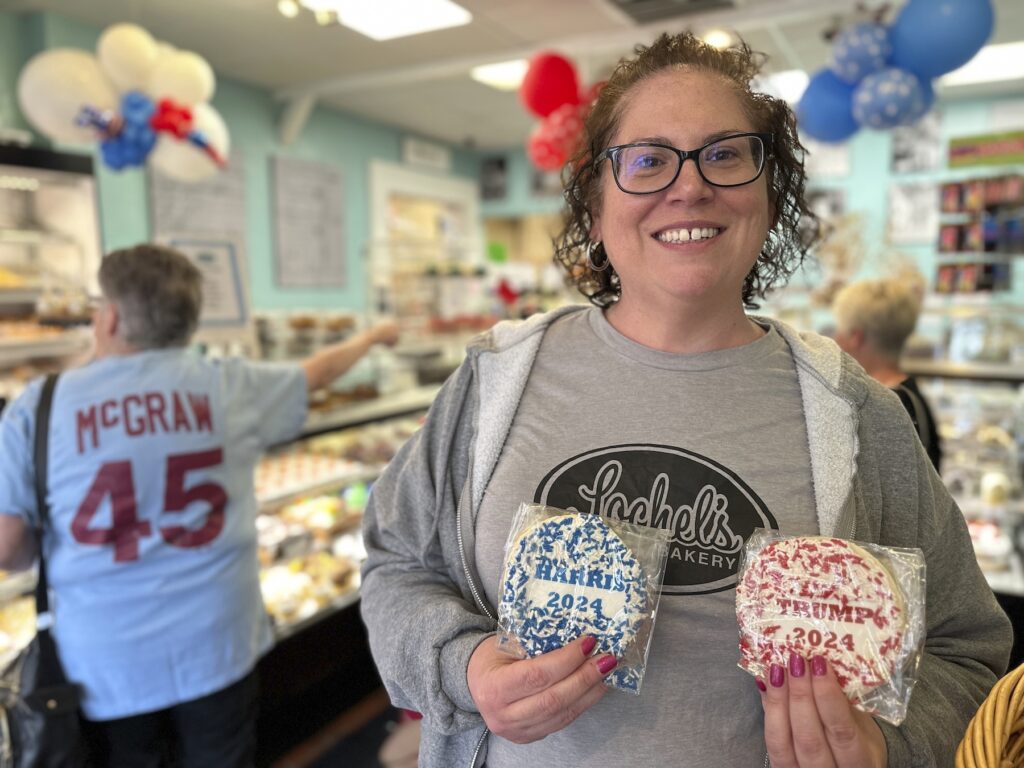 Kathleen Lochel holding up sugar cookies