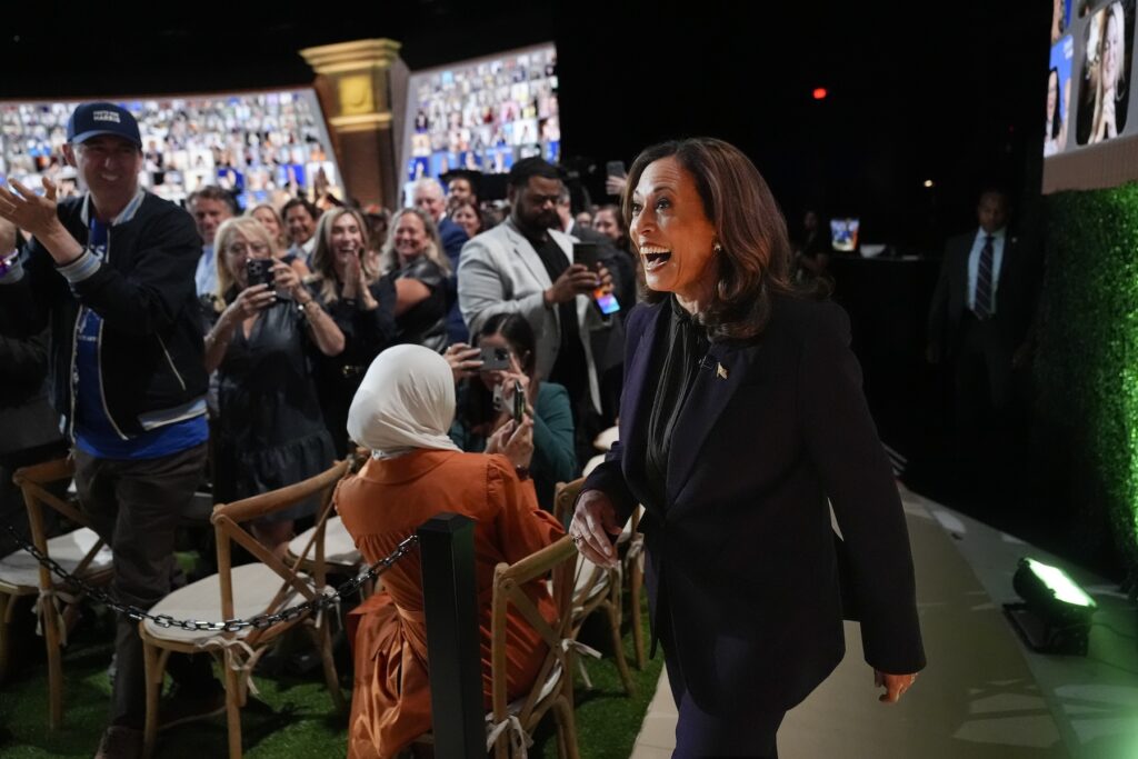 Kamala Harris walking onto the set with Oprah Winfrey