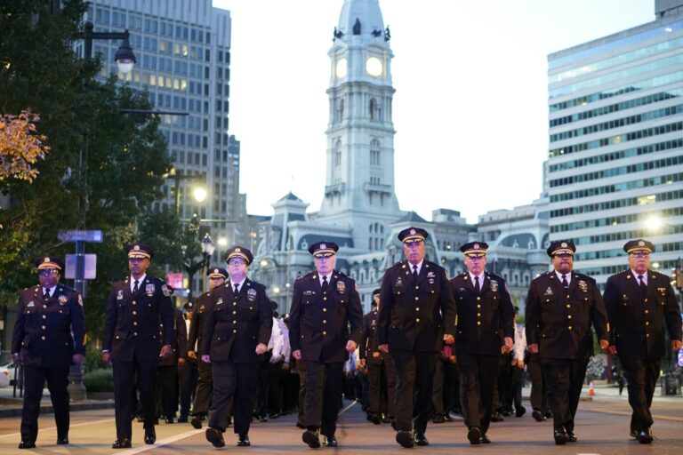 Officers walk through the street