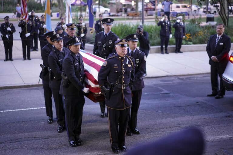 Officers carry the casket