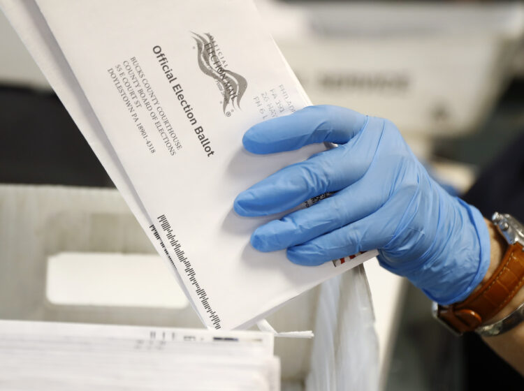 Worker processes mail-in ballots