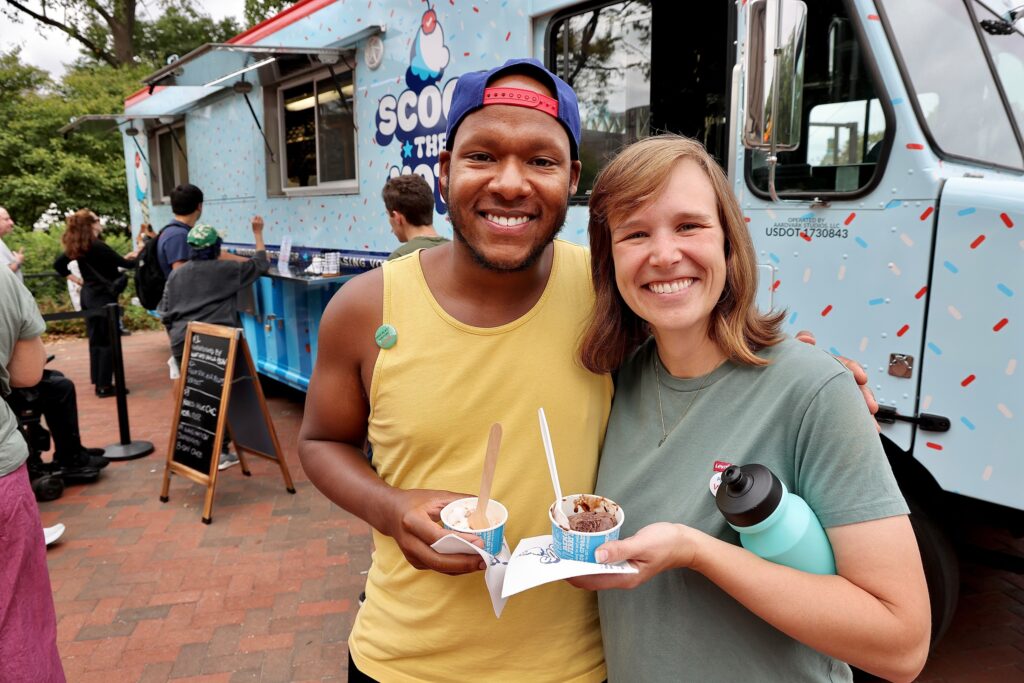 Emily Rutzen and Tyrone Sampson smile while holding ice cream