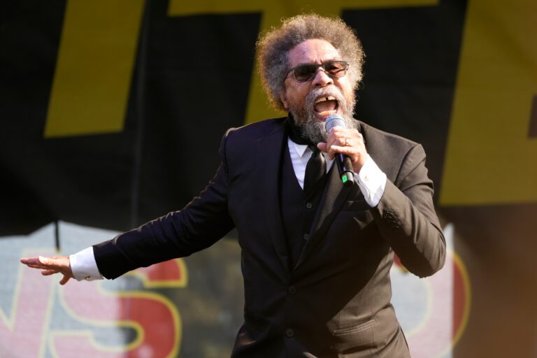 Cornel West speaks into a microphone