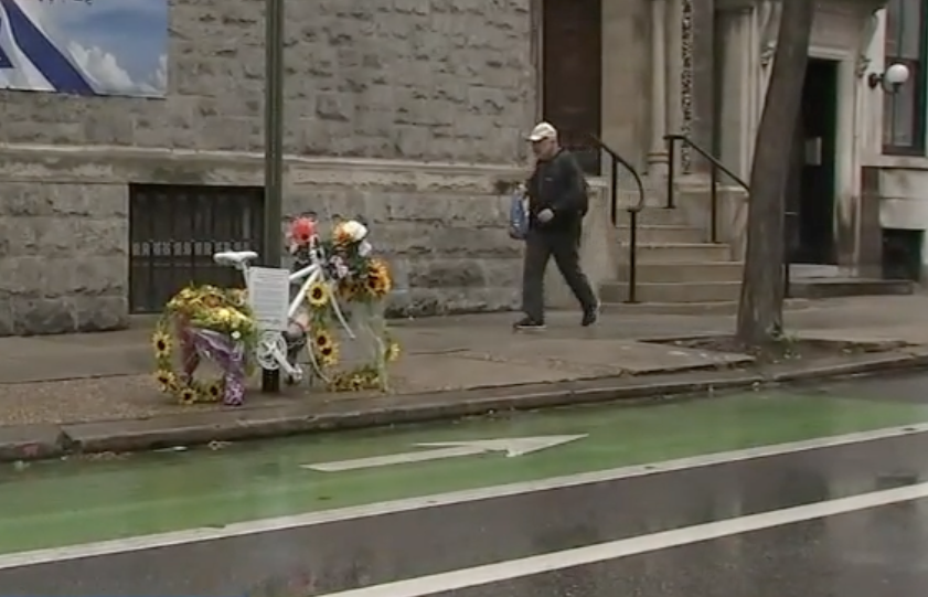 an Angel Bike with flowers sits as a memorial for Dr. Barbara Friedes