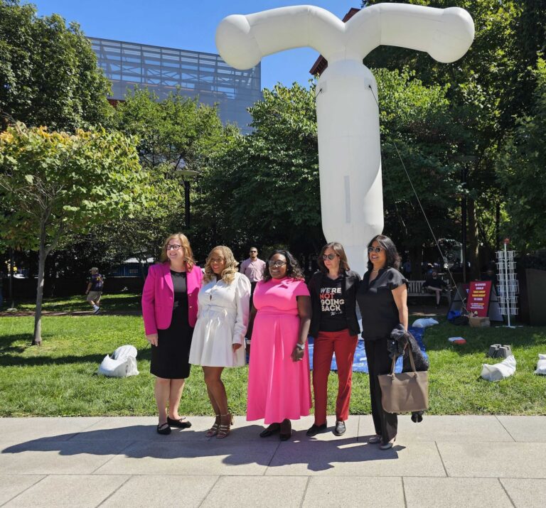 Philly City Councilmembers appear in front of a giant inflatable IUD