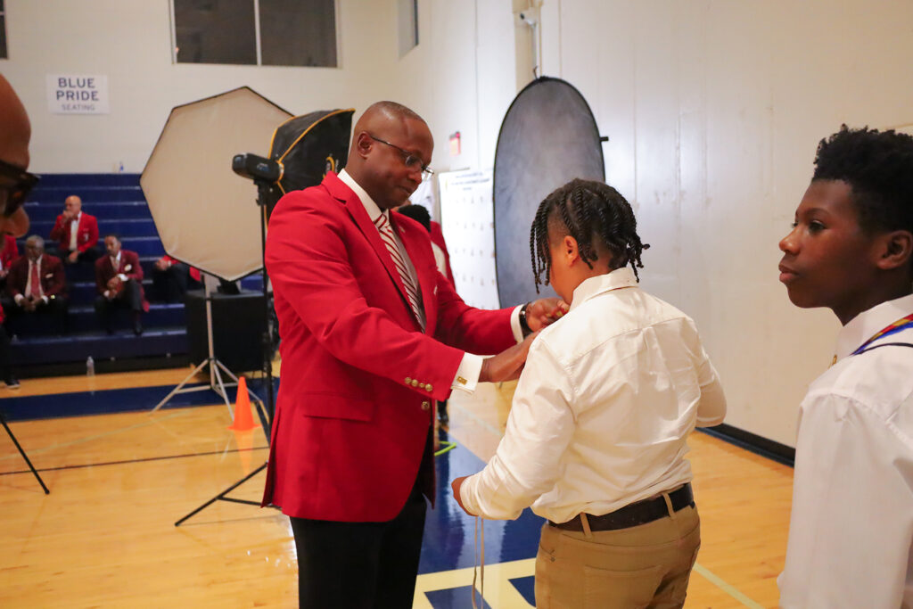 Kappa Alpha Psi Fraternity Inc. members check the ties on students at 'Kappa League