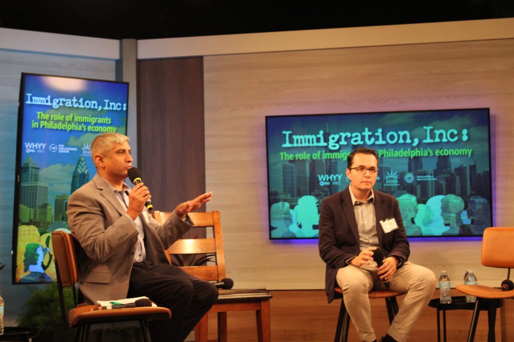 pew-event-3 Anuj Gupta, left, CEO of The Welcoming Center, speaks with Zeke Hernandez, right, a professor at University of Pennsylvania's Wharton School of Business and author of